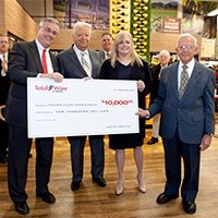 Total Wine associates, including owner, David Trone, present a check to a local charity.