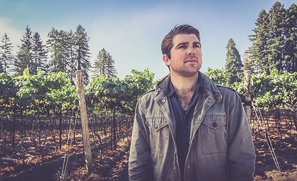 Joe Wagner standing in a vineyard.