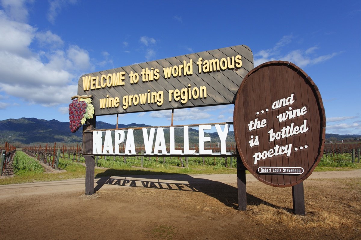 Napa Valley sign reads Welcome to this world famous wine growing region. Napa Valley '...and the wine is bottled by poetry...' -Robert Louis Stevenson