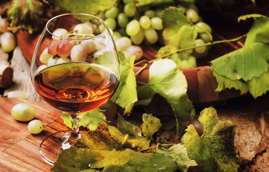 glass of cognac with grapes